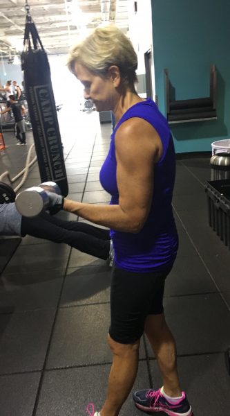 Penny F. at gym after successful treatment for hearing loss