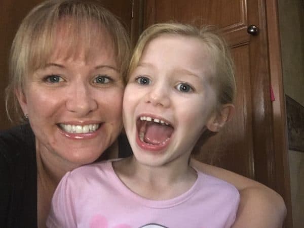 Mother with hearing loss from chronic ear infections with daughter