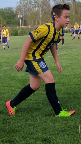 Teen with enlarged vestibular aqueduct syndrome playing soccer