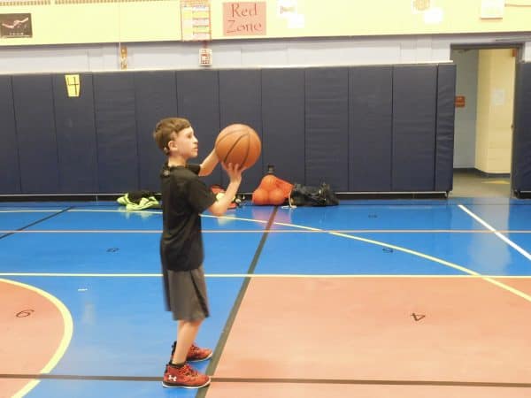 Matthew, a child with single-sided deafness, playing basketball