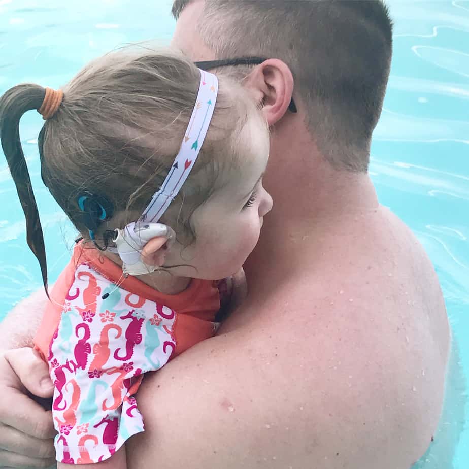 Gabby, who is unable to sign, in the pool and able to hear with a cochlear implant