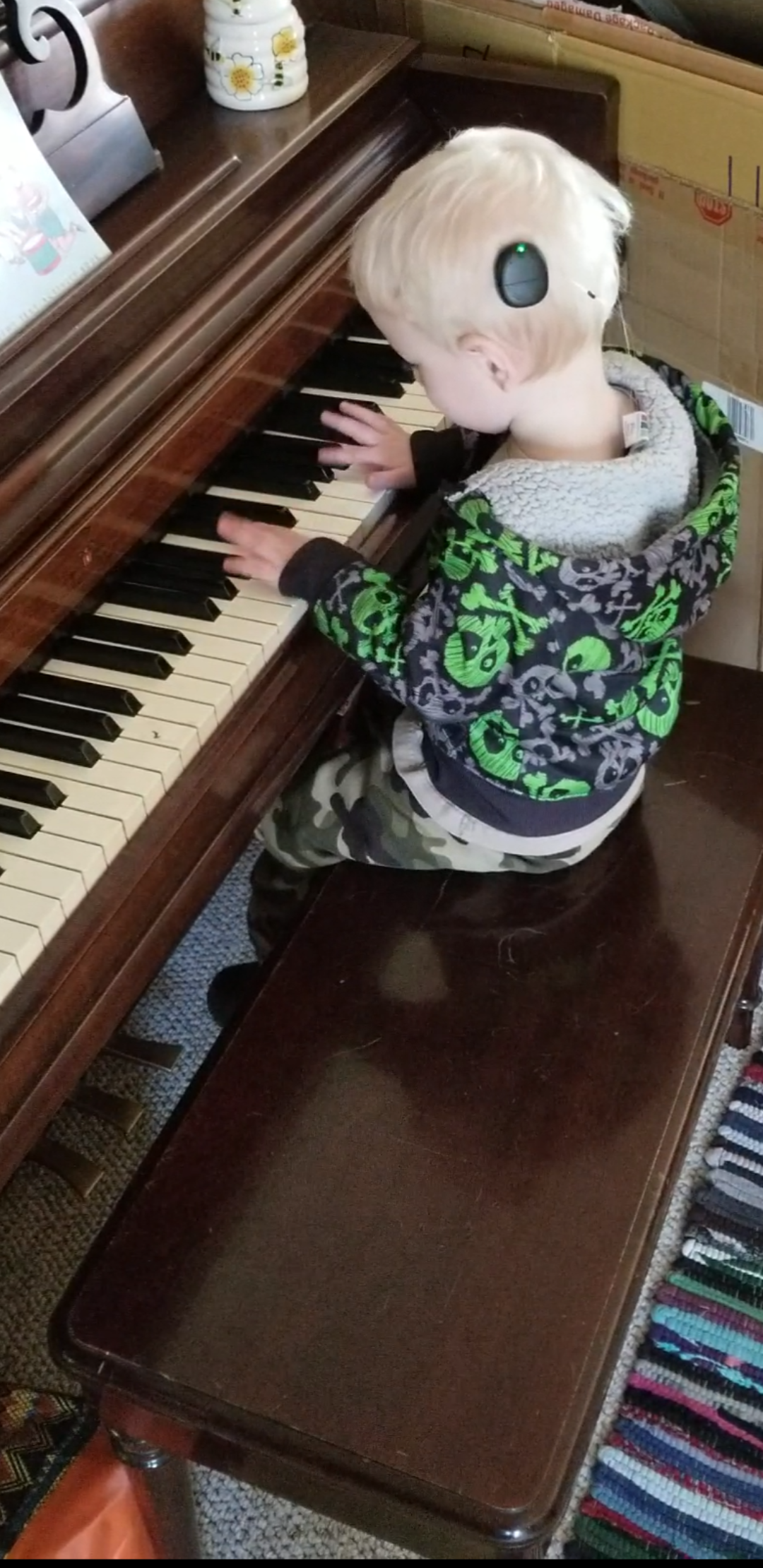 Jackson with off-the-ear processors playing piano