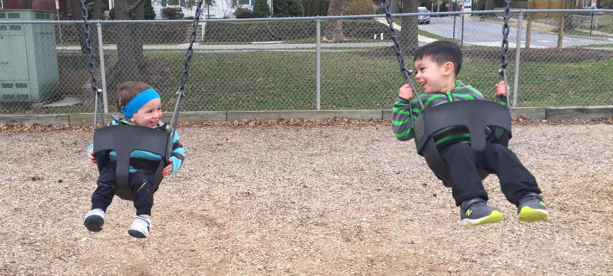 Shane swinging with his brother after being born with hearing loss