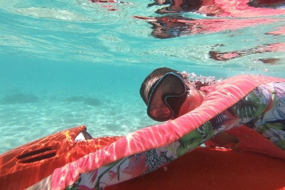 Alana is underwater snorkeling with her Aqua+ kit