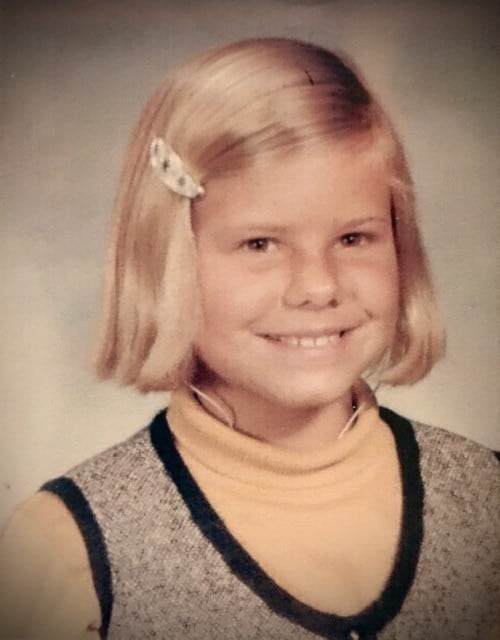 Cathy, who used to wear hearing aids, as a child