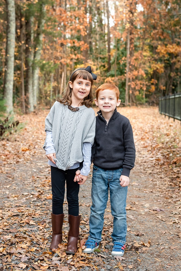 JT, who has progressive hearing loss, with his sister