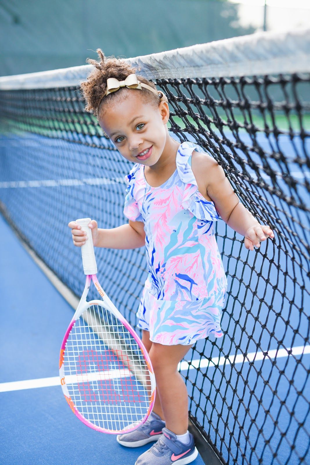 Child with auditory neuropathy spectrum disorder playing tennis