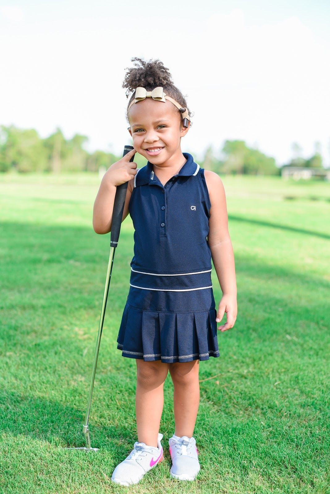 Child with auditory neuropathy spectrum disorder playing golf