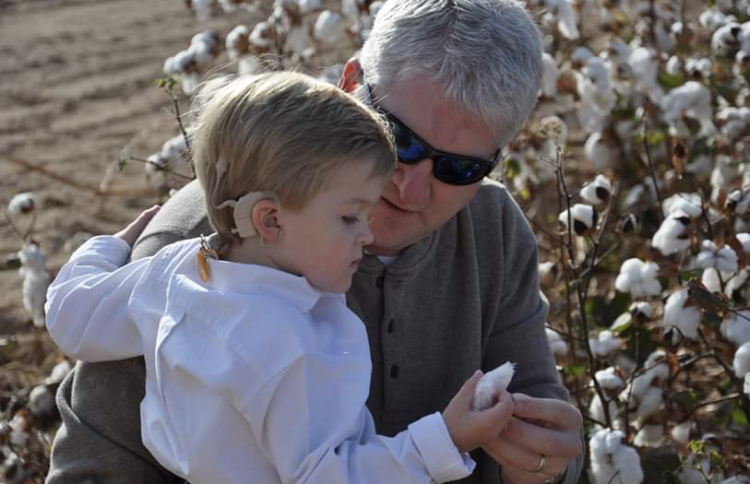 A father with his child who has congenital hearing loss
