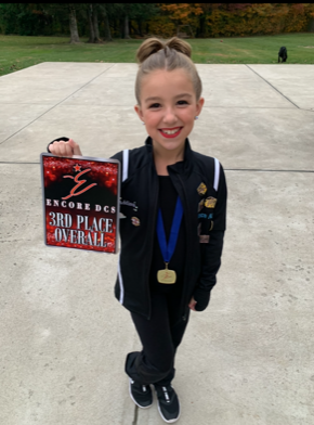 Addison, who has profound sensorineural hearing loss, with her dance award