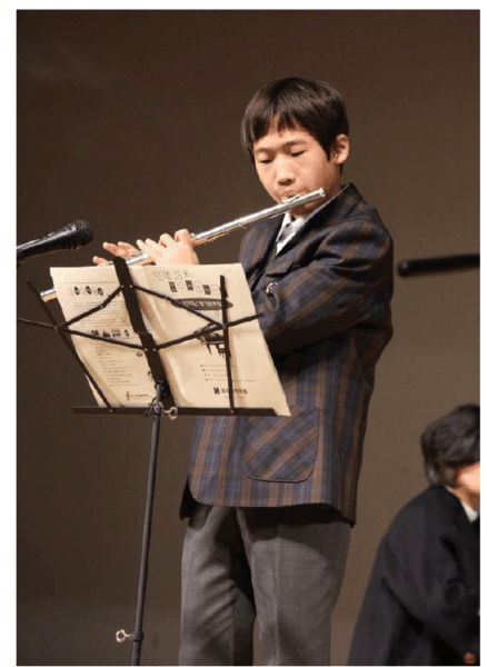 A young boy plays the flute and shares his experiences with Nucleus 7